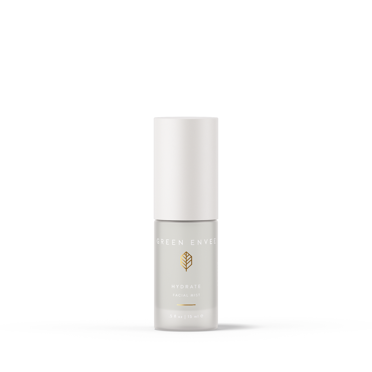 A travel-sized pump bottle of GREEN ENVEE Hydrate Facial Mist with the label showing the product name and ingredients.